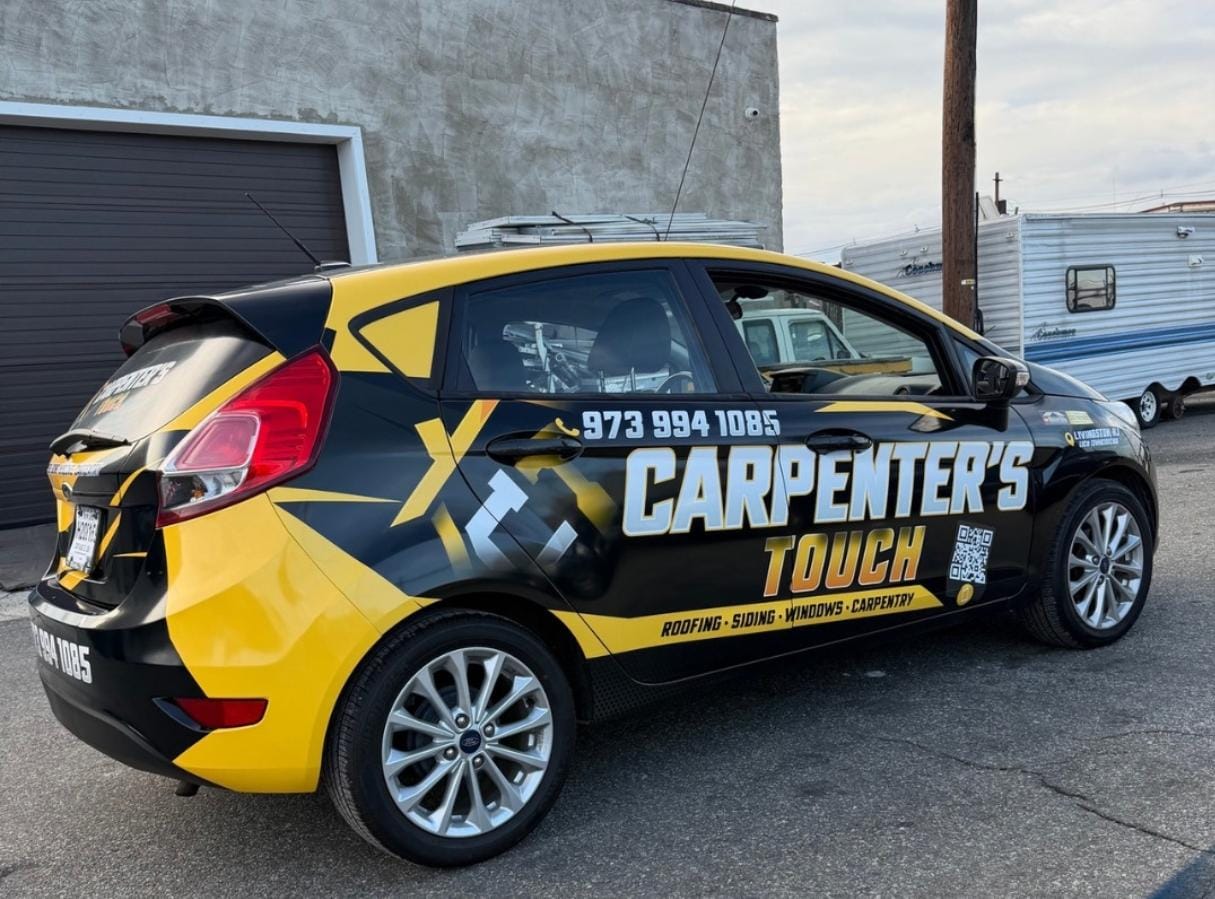 Carpenter's Touch hatchback with completed yellow and black commercial graphics