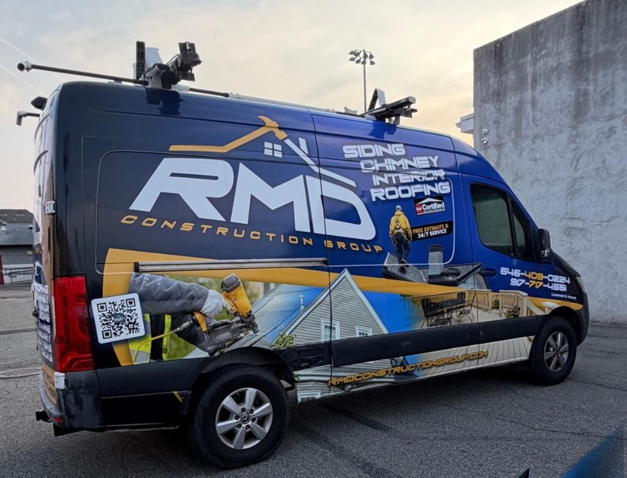 RMD Construction Group van with completed blue and yellow commercial wrap